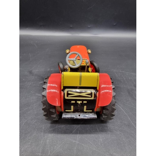 1412 - A tinplate clockwork tractor. 