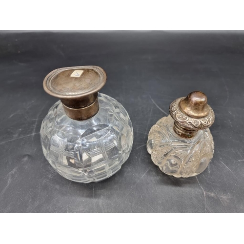 1420 - Two silver mounted cut glass scent bottles, largest 12.5cm high.