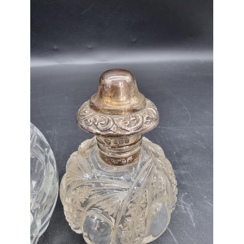 1420 - Two silver mounted cut glass scent bottles, largest 12.5cm high.