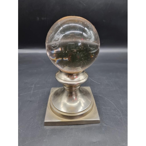 1429 - A crystal ball, on nickel plated stand, 20cm high; together with a brass casket, 8.5cm wide. ... 