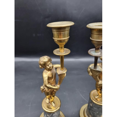 1434 - A pair of brass and marble figural candlesticks, 27.5cm high. 