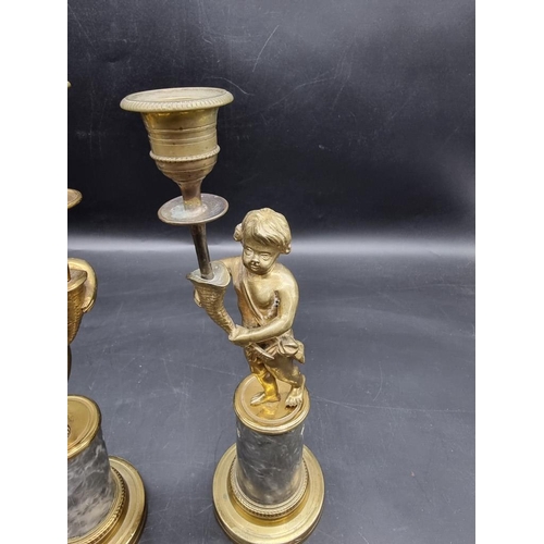 1434 - A pair of brass and marble figural candlesticks, 27.5cm high. 