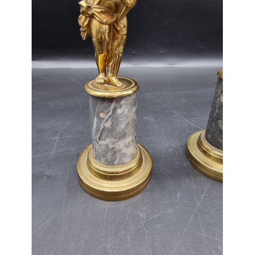 1434 - A pair of brass and marble figural candlesticks, 27.5cm high. 