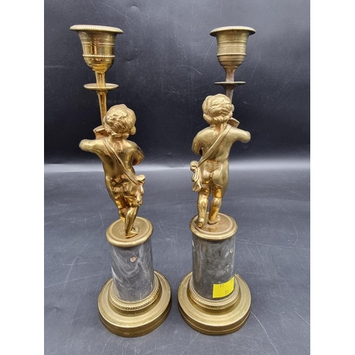 1434 - A pair of brass and marble figural candlesticks, 27.5cm high. 