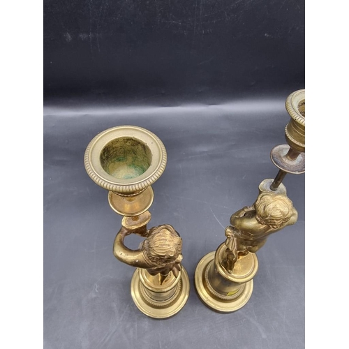 1434 - A pair of brass and marble figural candlesticks, 27.5cm high. 