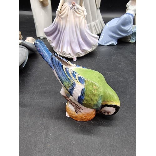 1447 - A Meissen blue tit, 8.5cm high; together with a Lladro figure group; two Nao figures; and two others... 