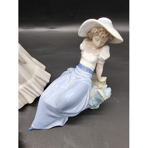 1447 - A Meissen blue tit, 8.5cm high; together with a Lladro figure group; two Nao figures; and two others... 