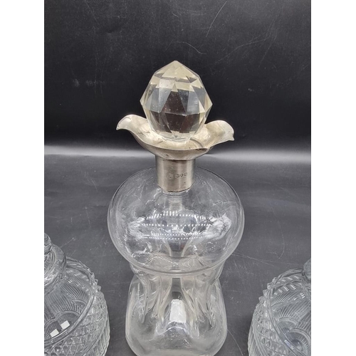 1452 - A silver mounted clear glass kluck kluck decanter and stopper, 27.5cm high; together with another pa... 