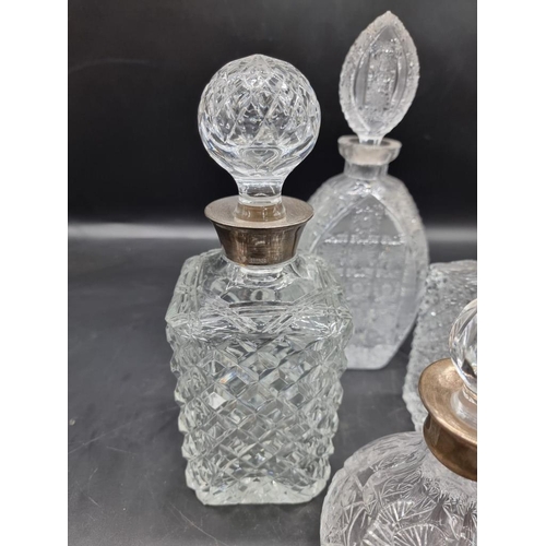 1463 - Two silver mounted decanters and stoppers; together with two other decanters and stoppers. (4) ... 