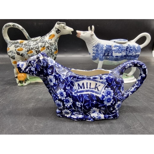 1474 - Five pottery cow creamers, to include an interesting 19th century Prattware example with milkmaid, 1... 