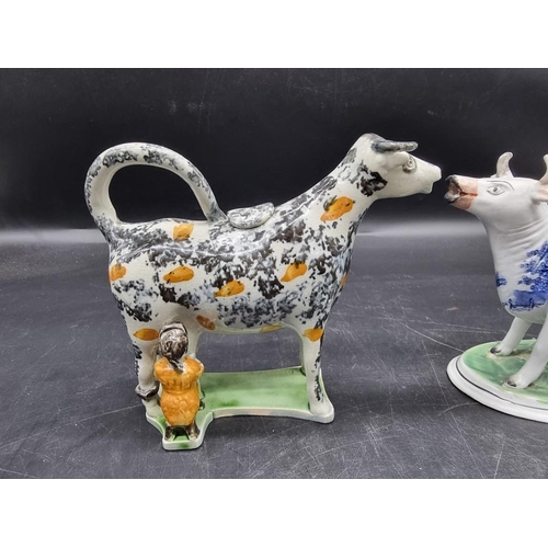 1474 - Five pottery cow creamers, to include an interesting 19th century Prattware example with milkmaid, 1... 