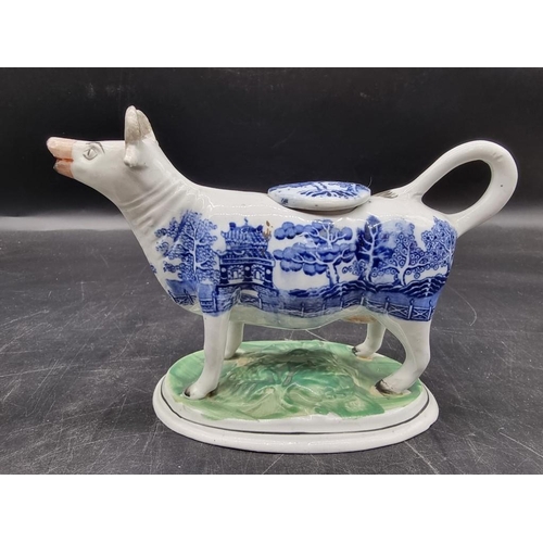 1474 - Five pottery cow creamers, to include an interesting 19th century Prattware example with milkmaid, 1... 