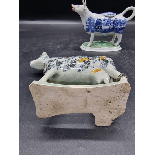 1474 - Five pottery cow creamers, to include an interesting 19th century Prattware example with milkmaid, 1... 