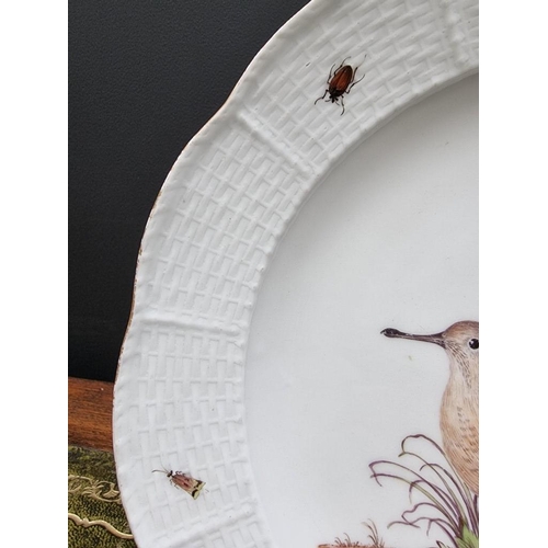 1500 - A 19th century Meissen plate, painted with a wading bird and insects, with basketweave boarder, 24.5... 