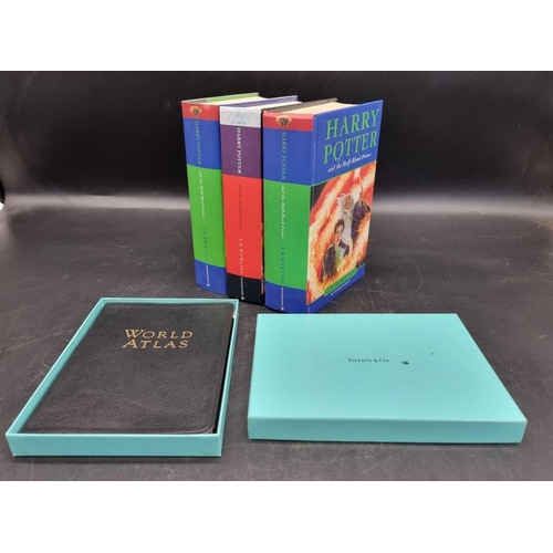 1567 - Books: a Tiffany & Co leather bound world atlas, 4to, boxed; together with three Harry Potter fi... 