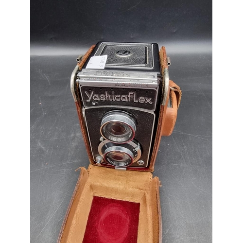 1578 - Cameras: a YashikaFlex, in leather case.  