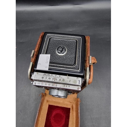 1578 - Cameras: a YashikaFlex, in leather case.  