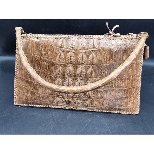 1584 - A crocodile skin handbag. 