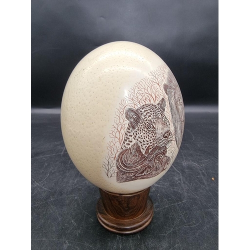 1606 - Natural History: a ostrich egg, painted with African animals, signed Dumi, on wood stand.... 