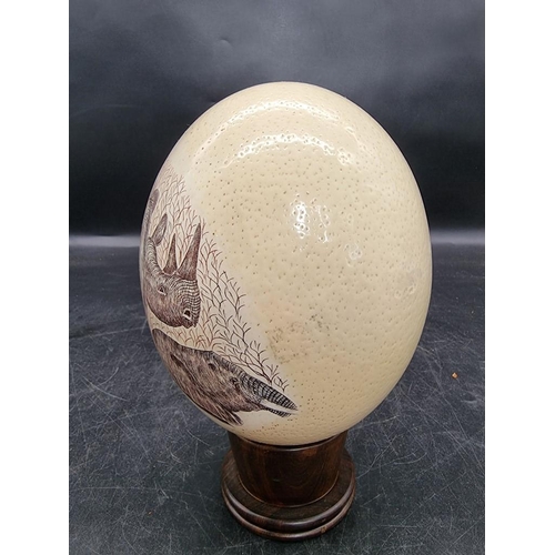 1606 - Natural History: a ostrich egg, painted with African animals, signed Dumi, on wood stand.... 