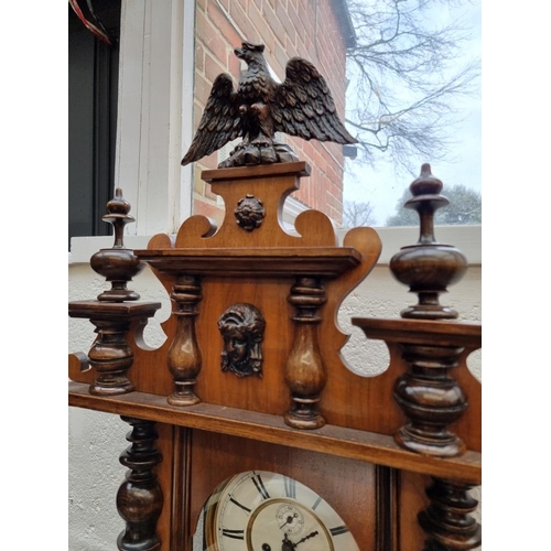 1677 - A late 19th century walnut Vienna style wall clock, 139cm high, with weights and pendulum. ... 