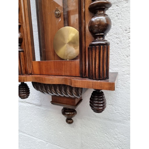 1677 - A late 19th century walnut Vienna style wall clock, 139cm high, with weights and pendulum. ... 