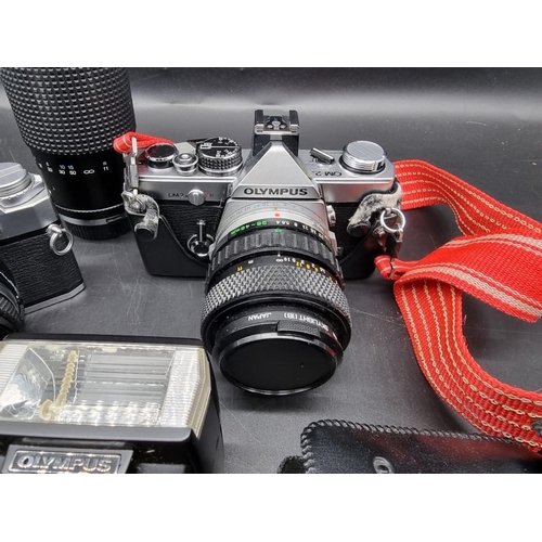 1689 - Cameras: an Olympus OM-2n, with 28-48mm 1:4 lens; together with an Olympus OM30, with 1:1.8 f=50mm l... 