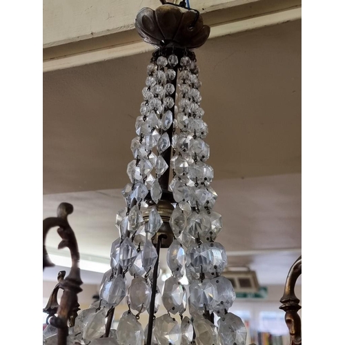 1701 - An antique brass and facetted glass chandelier, approx 54cm high, (losses).