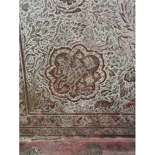 1712 - A large Persian or Indian copper rectangular tray, engraved with stylized figures and with a line of... 