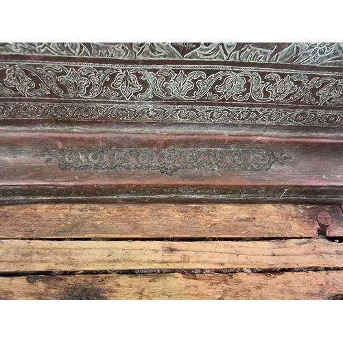 1712 - A large Persian or Indian copper rectangular tray, engraved with stylized figures and with a line of... 