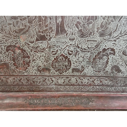 1712 - A large Persian or Indian copper rectangular tray, engraved with stylized figures and with a line of... 