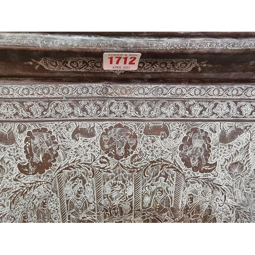 1712 - A large Persian or Indian copper rectangular tray, engraved with stylized figures and with a line of... 