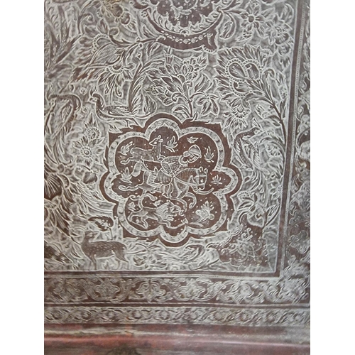 1712 - A large Persian or Indian copper rectangular tray, engraved with stylized figures and with a line of... 