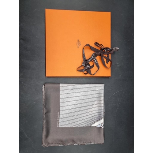 1720 - Hermes: a brown and grey 'Vent Portant II' pattern silk scarf, in original box with ribbon.... 