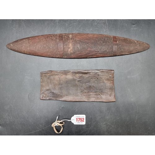 1752 - Ethnographica: an Australian Aboriginal Churringa, 43cm long; together with another similar carved w... 