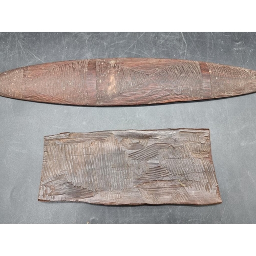 1752 - Ethnographica: an Australian Aboriginal Churringa, 43cm long; together with another similar carved w... 