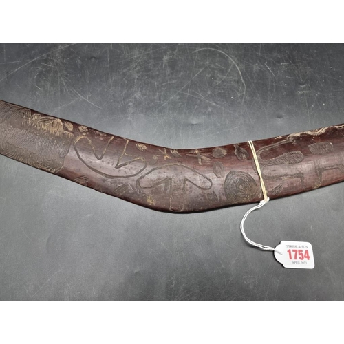 1754 - Ethnographica: a 19th century Australian Aboriginal hardwood boomerang, the upper convex side decora... 