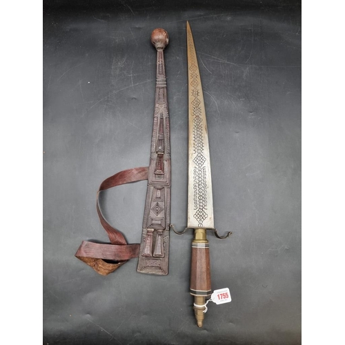 1755 - Ethnographica: an African sword and embossed leather scabbard, probably Nigerian, with 55cm blade.... 