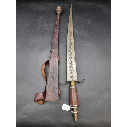 1755 - Ethnographica: an African sword and embossed leather scabbard, probably Nigerian, with 55cm blade.... 