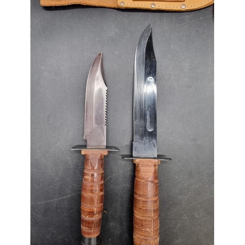 1767 - Two Bowie knives and leather sheaths, the blades 17.5cm and 12.5cm respectively.... 