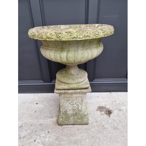 1791 - A large composition stone Campana urn on pedestal, 62cm diameter x 90cm high.