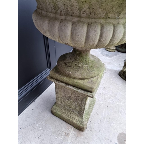 1791 - A large composition stone Campana urn on pedestal, 62cm diameter x 90cm high.