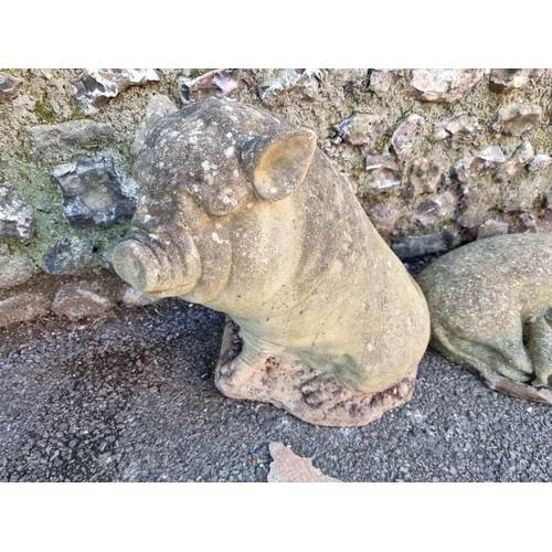 1792 - A composition stone pig, 42cm high; together with another similar figure group of sow and piglets, 5... 