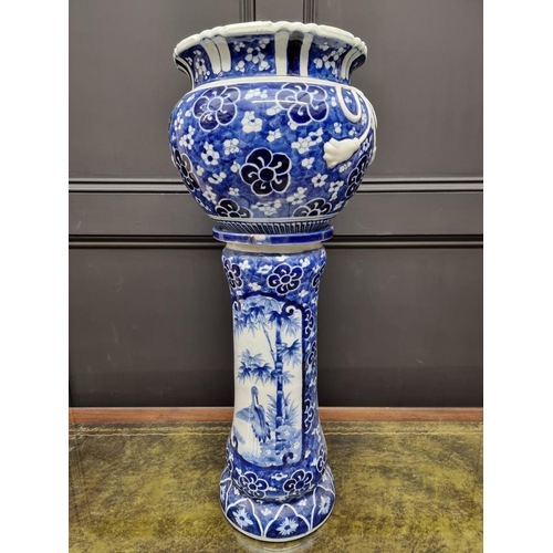 1795 - A Japanese blue and white jardiniere and pedestal, 72cm high, (repairs to jardiniere).... 