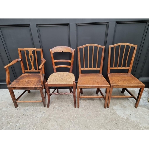 1823 - A pair of early 19th century elm dining chairs; together with another elm elbow chair; and another r... 