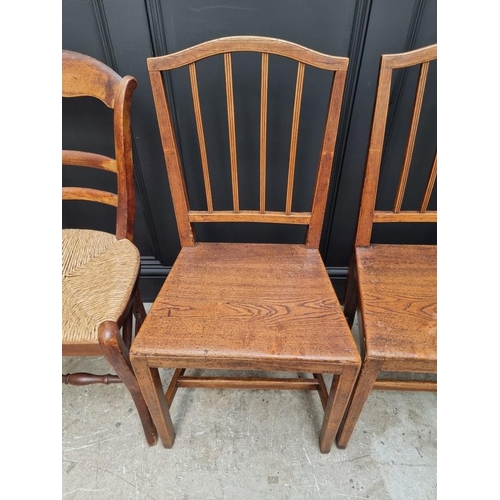 1823 - A pair of early 19th century elm dining chairs; together with another elm elbow chair; and another r... 