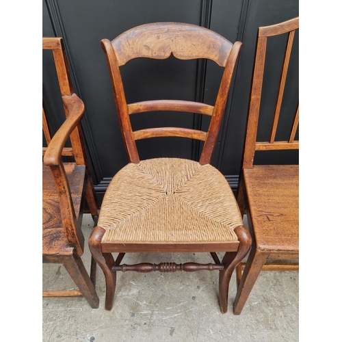 1823 - A pair of early 19th century elm dining chairs; together with another elm elbow chair; and another r... 