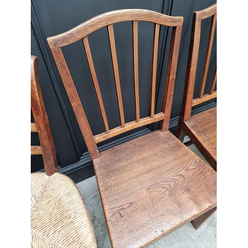 1823 - A pair of early 19th century elm dining chairs; together with another elm elbow chair; and another r... 