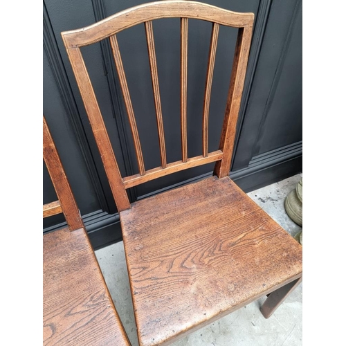 1823 - A pair of early 19th century elm dining chairs; together with another elm elbow chair; and another r... 