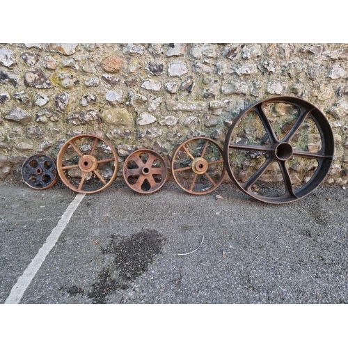 1824 - Five old iron wheels, largest, 60cm wide.